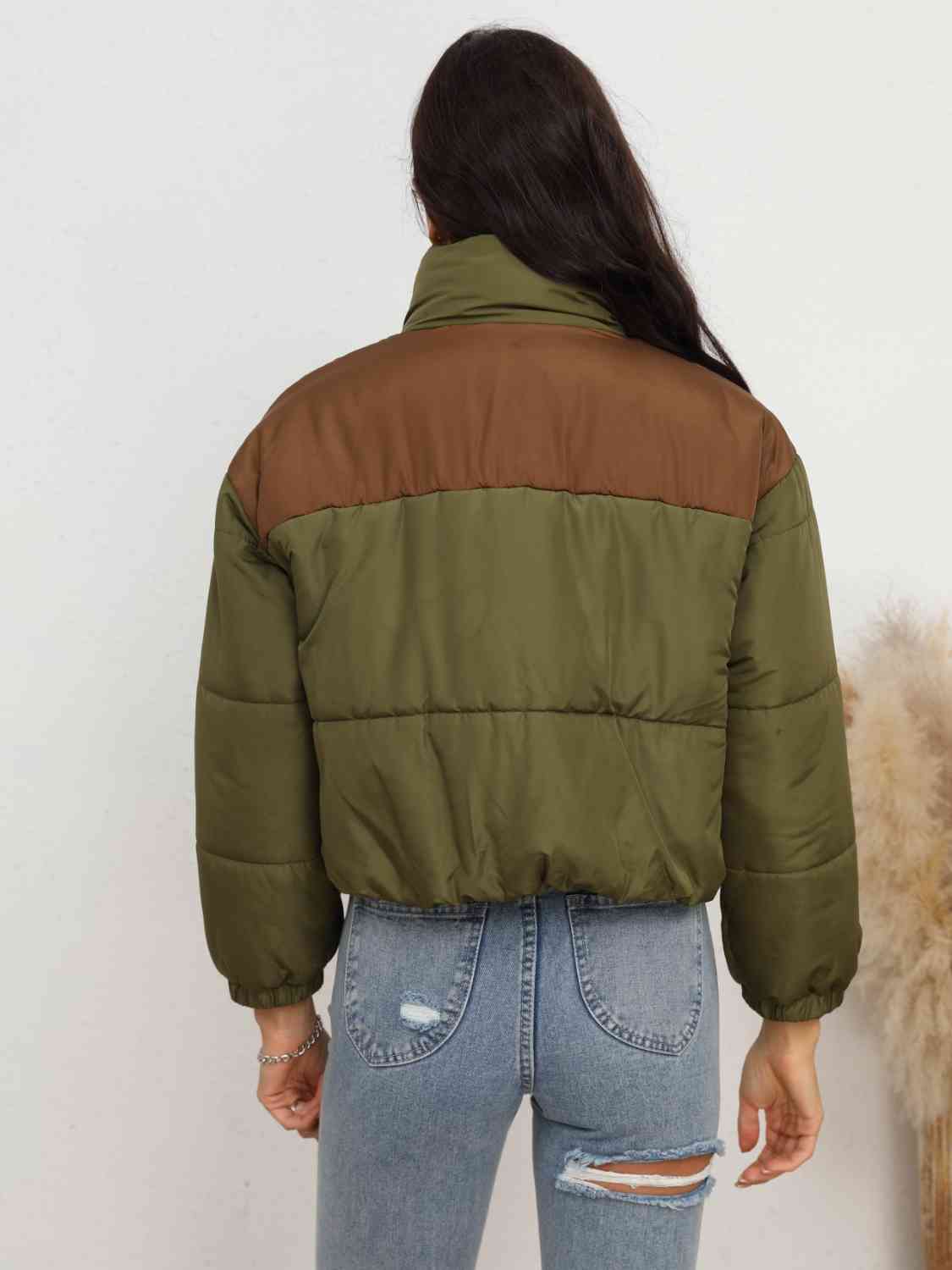A 'Zip-Up Puffer Jacket,' a cold-weather outerwear piece designed for insulation and warmth, typically featuring a zipper closure for easy wear and a quilted puffer design for added insulation and style.
