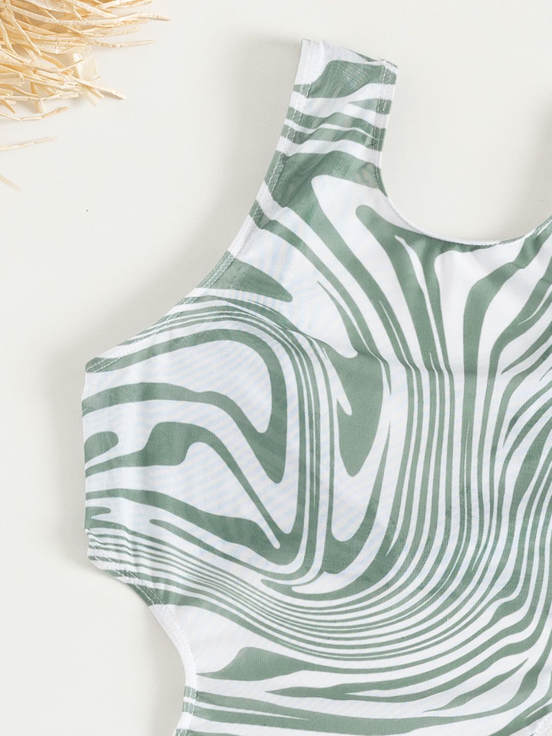 Alexis Swim Set displayed on a mannequin, featuring a vibrant tropical print with a flattering scoop-neck top and matching high-waisted bottoms, perfect for a day at the beach or pool.