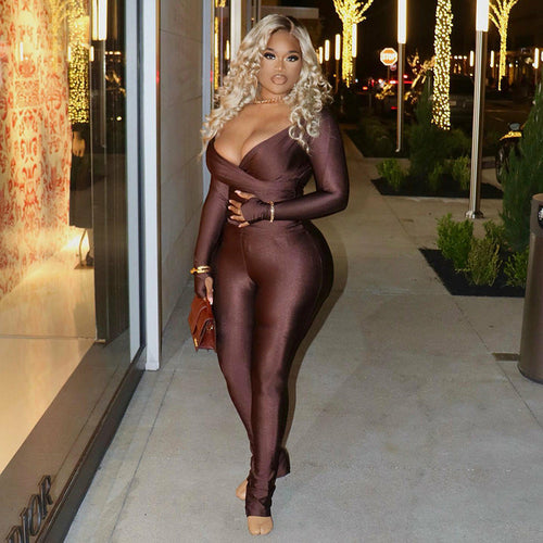 A solid ankle-length jumpsuit, characterized by its one-piece design in a single color and a length that extends to the ankles.