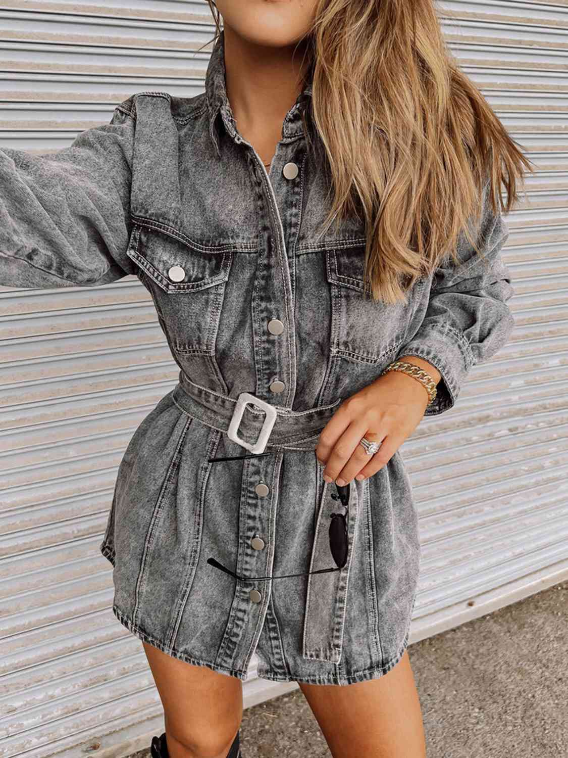 A buttoned denim dress, offering a fashionable and comfortable outfit with its classic denim fabric and front-button closure.