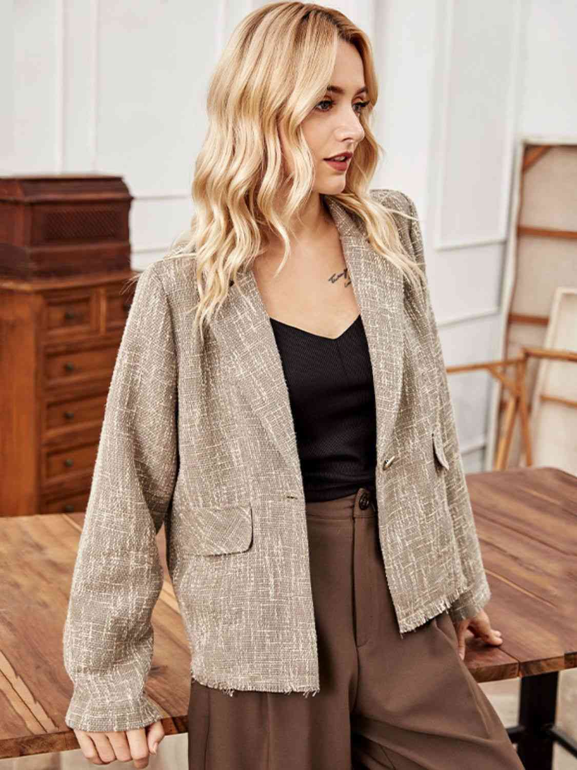 A long sleeve blazer, offering a sophisticated and professional style with its extended sleeves for a polished appearance.