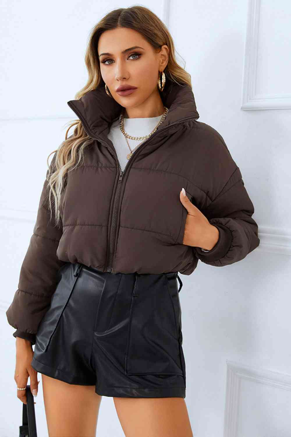 a warm and stylish winter coat in a rich, deep shade of navy blue. The coat features a faux fur-lined hood, zippered front, and ample pockets for added convenience. Perfect for staying cozy and fashionable during the cold winter months.A winter coat designed for warmth and functionality, featuring multiple spacious pockets for added convenience.
