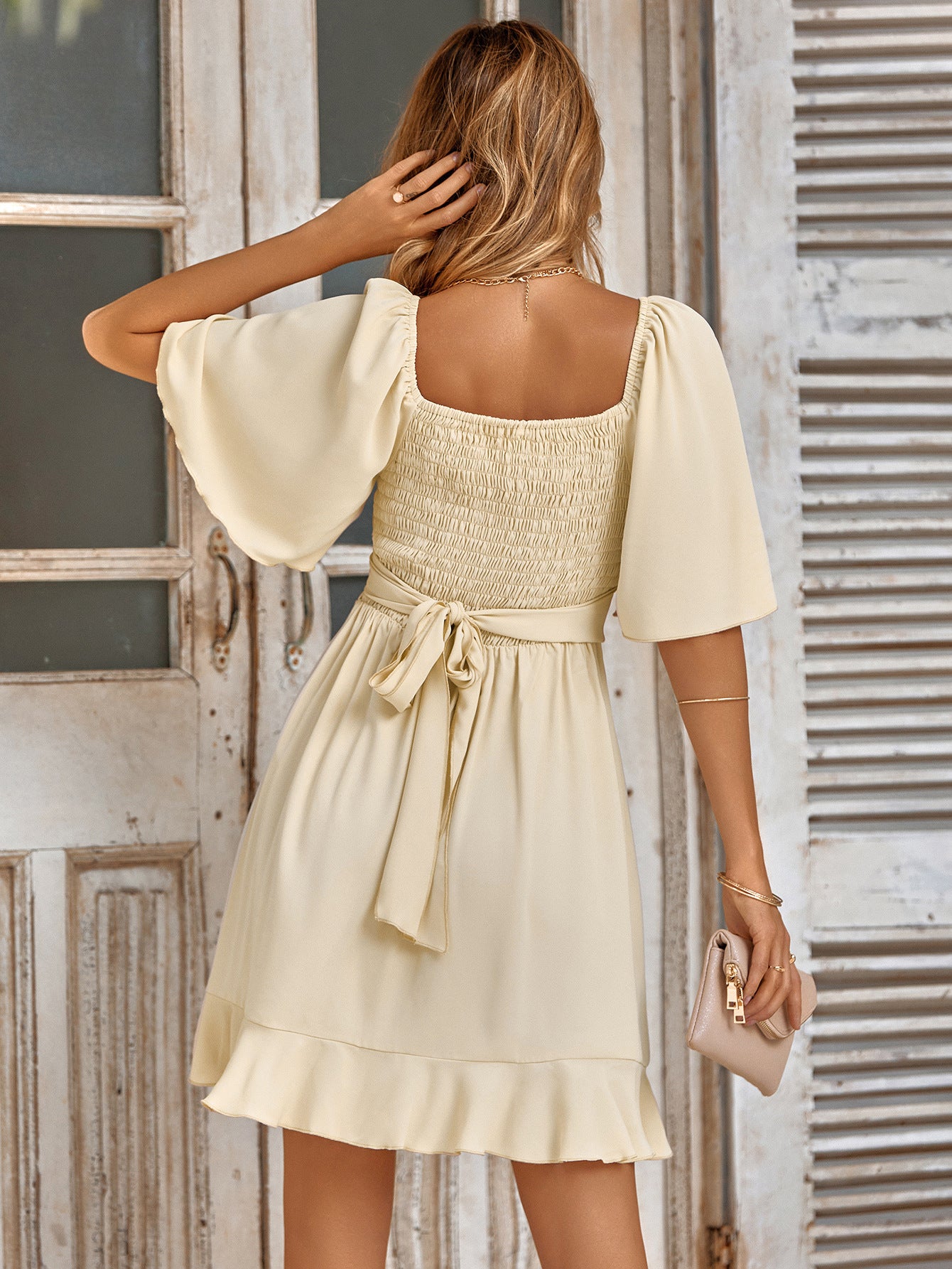 Mini Surplice Dress' highlighting a short, wrap-style dress with a surplice neckline, creating a flattering and stylish look.