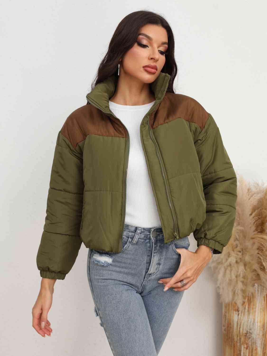 A 'Zip-Up Puffer Jacket,' a cold-weather outerwear piece designed for insulation and warmth, typically featuring a zipper closure for easy wear and a quilted puffer design for added insulation and style.