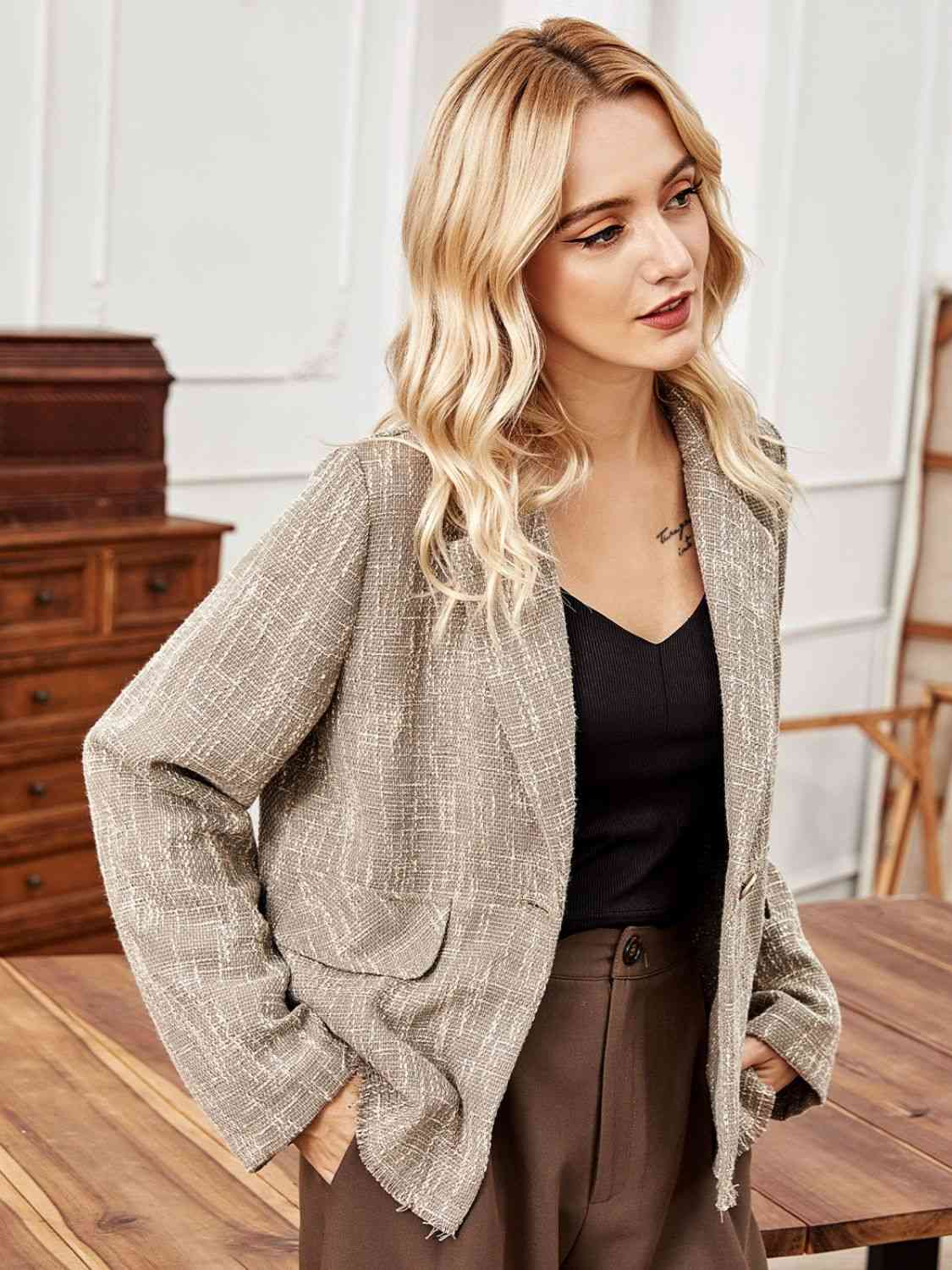 A long sleeve blazer, offering a sophisticated and professional style with its extended sleeves for a polished appearance.