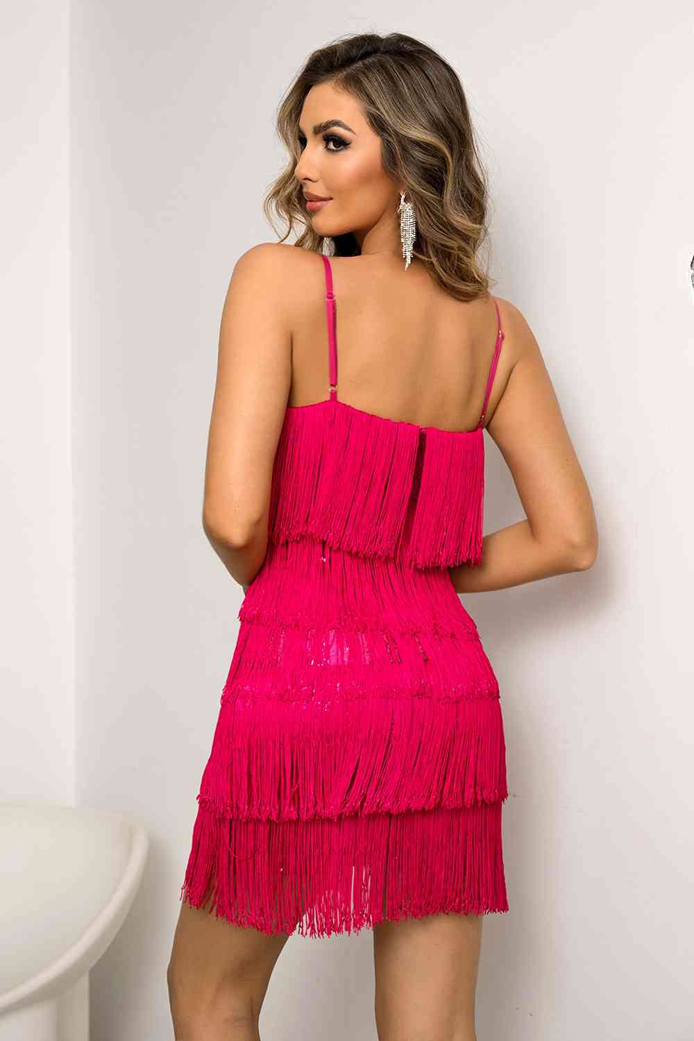 A chic mini dress adorned with playful fringes, adding a touch of fun and movement to your outfit.