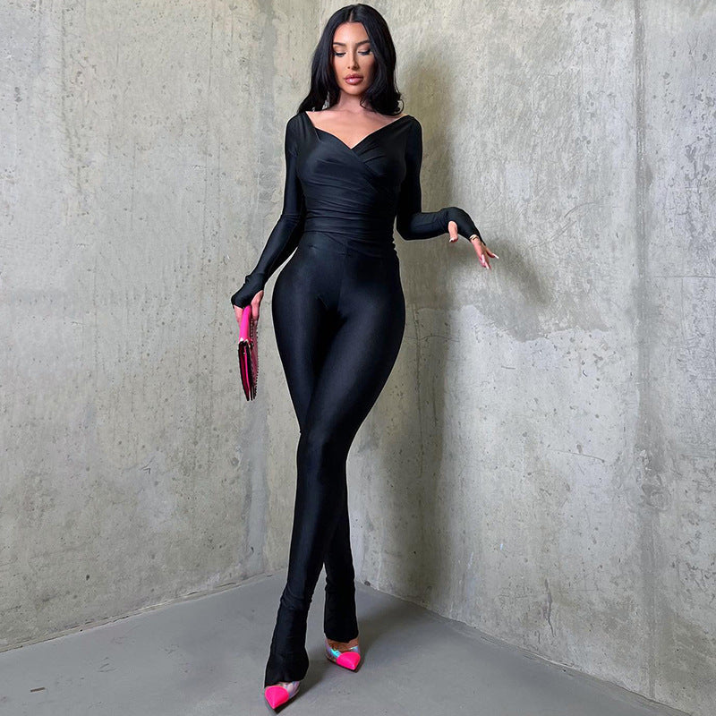 A solid ankle-length jumpsuit, characterized by its one-piece design in a single color and a length that extends to the ankles.